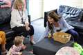 One-year-old baby takes toys from Kate at child support hub