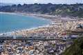 Beachgoers soak up the sunshine as mercury rises to almost 23C