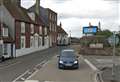 Road blocked and biker hurt after collision with wall