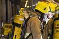 Fire spreads up ivy growing on house