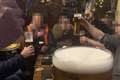 Men pictured drinking pints at seaside hotel with caption ‘What Lockdown?’