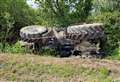 Car and tractor in ditch after crash