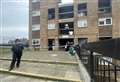 Woman denies murder after man found dead in flats