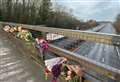 Floral tributes at motorway bridge after young woman’s tragic death