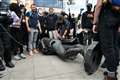 Police investigate after protesters pull down statue of slave trader