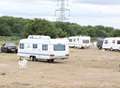 Travellers park up behind old garage