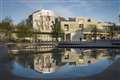 Climate protesters spray Scottish Parliament building red