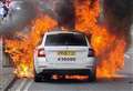 Taxi bursts into flames on main road