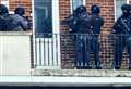 Armed police pictured at town centre block of flats