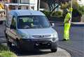 Workers forced to lay new road surface around parked van