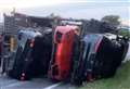 Luxury sports cars damaged after transporter overturns