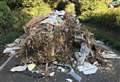 Fly-tipped rubbish mountain blocks road