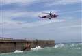 Dramatic moment two men in dinghy rescued from pier