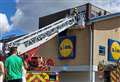 Firefighters work to save cat stuck on Lidl roof