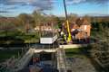 Crane lifts pool out of spa block at home of Captain Tom’s family