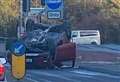 Car flips on roof near police station