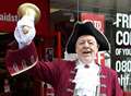 Town crier yells news of shop re-opening