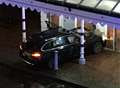 Car smashes into building near station