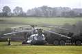 Heavy-lifting equipment used to free military helicopter stuck in muddy field