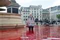 Two arrested after protesters dye Trafalgar Square fountains red