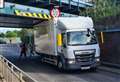 Road blocked as lorry hits rail bridge