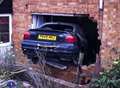 Car smashes into living room