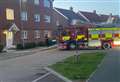 Flats evacuated after car crashes into wall