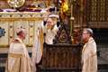 Archbishop spends several seconds adjusting crown for King during ceremony