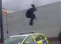 Yob caught on video trashing police car