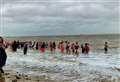 Swimmers in fancy dress take to sea for postponed New Year’s dip