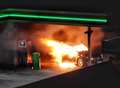 Car engulfed in flames at petrol station