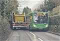 Bus and skip lorry get wedged along narrow road