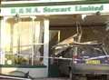 Car crashes through office window