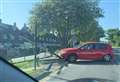 Car ploughs into bus stop