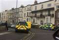 Road closed as police and fire crews called to block of flats