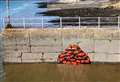 Mural of huge pile of lifejackets appears on sea wall