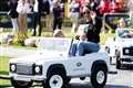 Harry and Meghan go for a spin in mini cars driven by children at Invictus Games