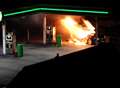 Manhunt after petrol station car blaze