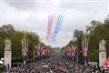 King and Queen watch scaled-down flypast from palace balcony