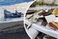 Huge chunks of sunken boat wash up on shore