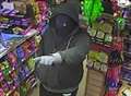 Hunt for robber who threatened shop staff with 'firearm'