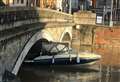 Boat drifts away and becomes stuck under bridge