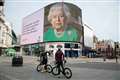 Queen’s image and message of hope light up Piccadilly Circus