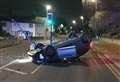 Boy, 16, arrested after car flips over in high street crash