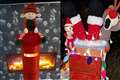 Crocheted ‘cheeky’ elves and Santa in a chimney adorn postboxes