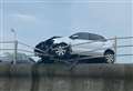 Car smashes through seafront barrier