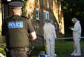 Forensic officers tape off flats and footpath