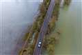 Cars return to road used by kayakers while flooded for two months