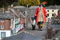 Town crier drives sheep through model village in nod to honorary privilege