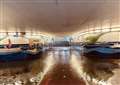 Teens jump barriers to cross road as underpass floods